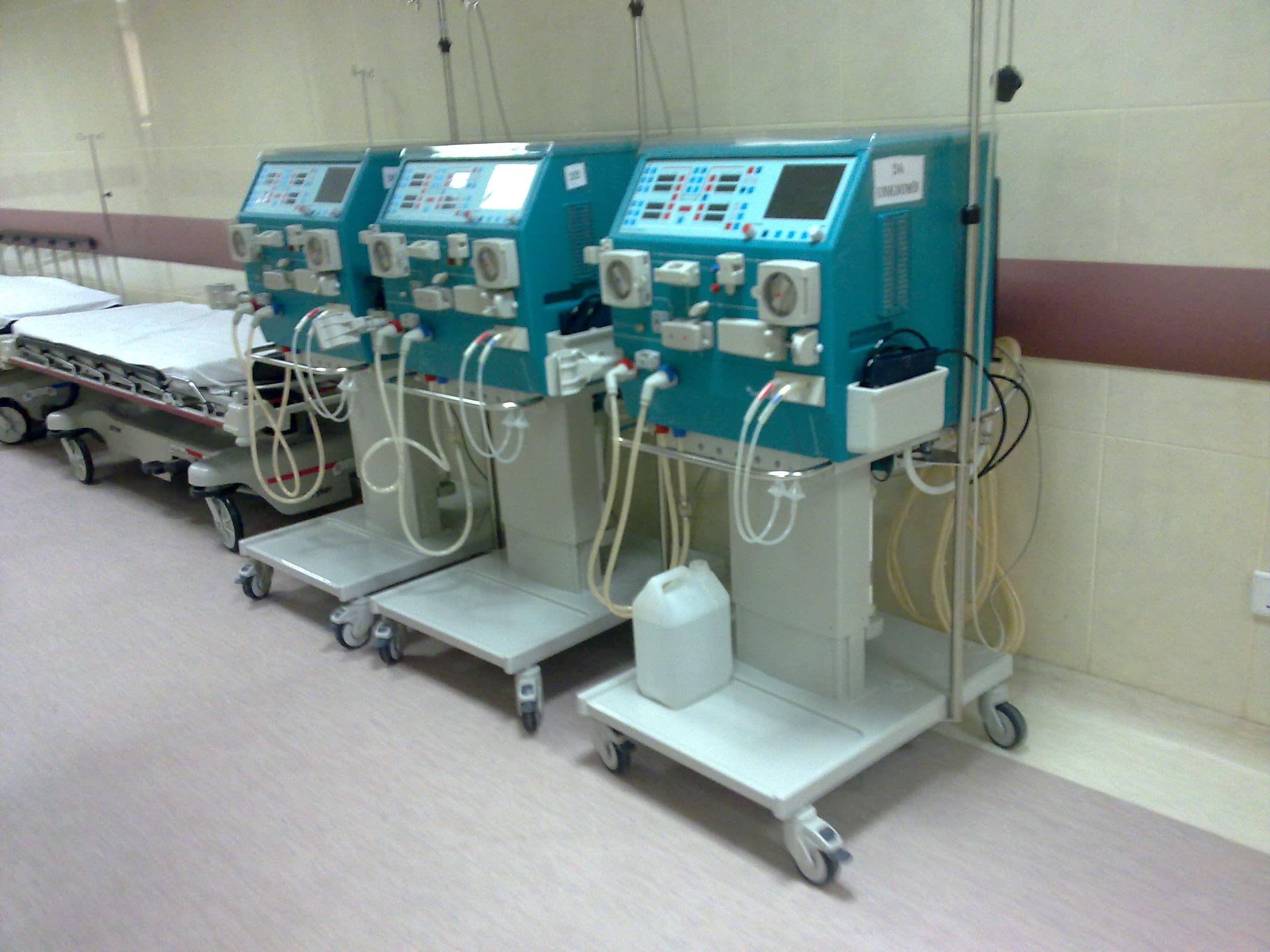 Rows of dialysis machines in a clinical setting, representing patients awaiting kidney transplantation